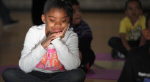 Student being mindful during yoga at school