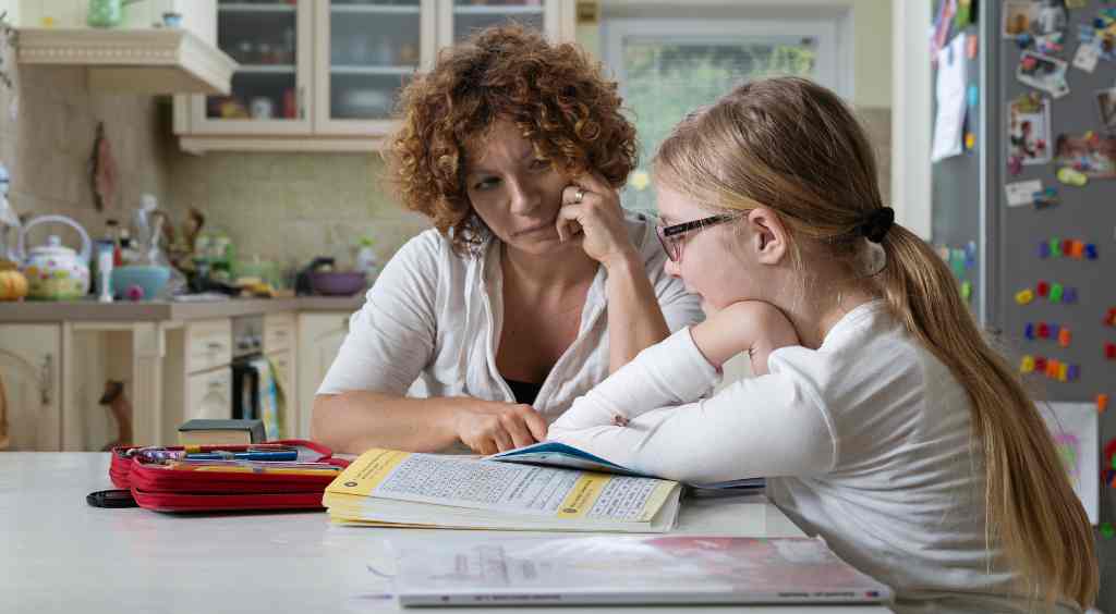 mom helping kid with homework
